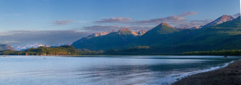 An Alaskan landscape with mountains, grassland, and water