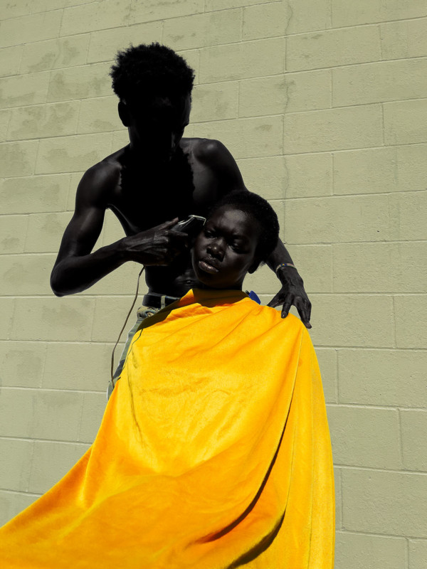 barber cutting hair of female