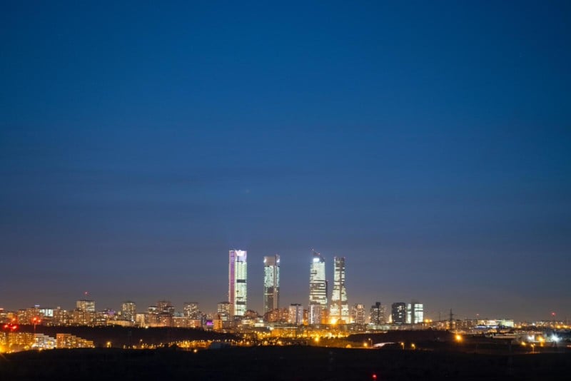 A photo of the Four Towers of Madrid with Comet Leonard over them