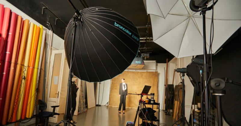 A woman posing for a portrait in front of a large Broncolor Para light