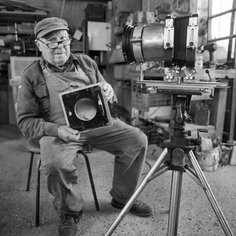 A man sitting with a large format camera