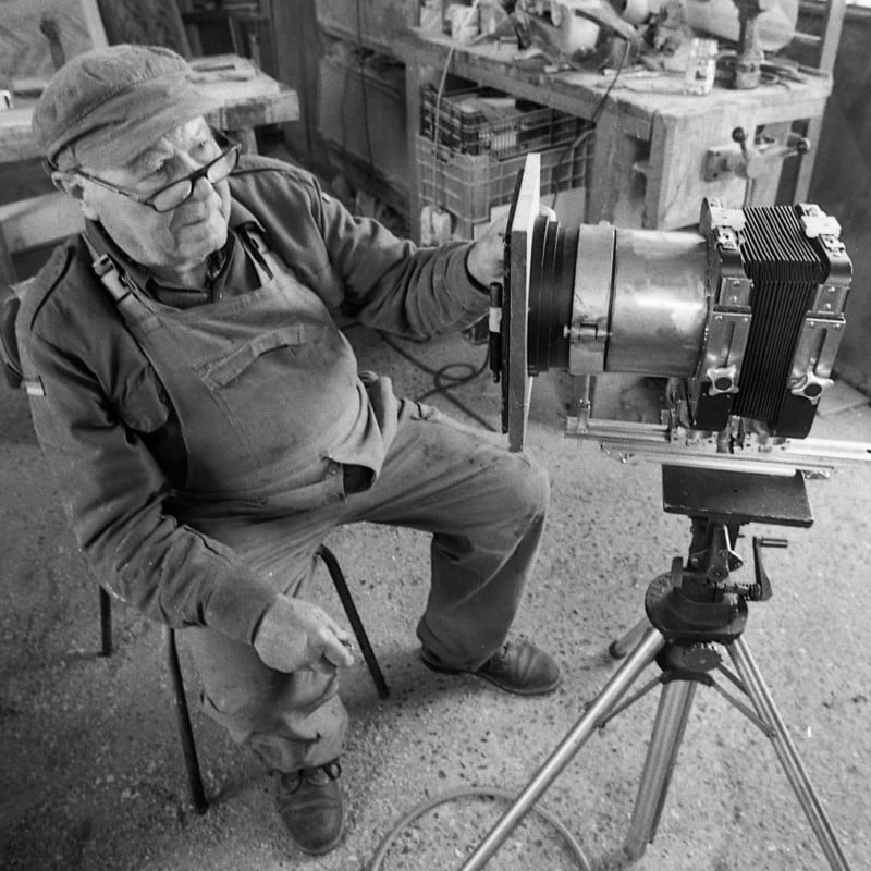 A man sitting with a large format camera