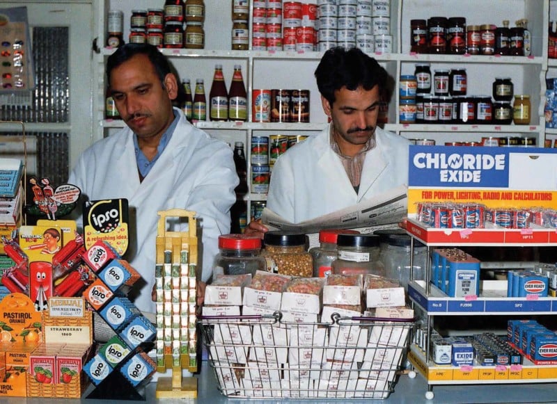 Two men behind the counter of a store