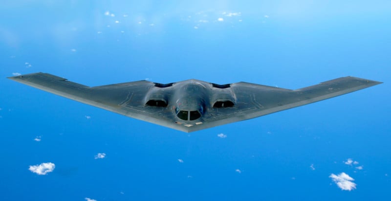A B-2 stealth bomber flying over an ocean