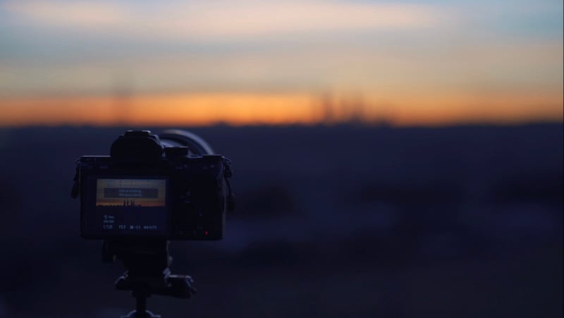 A camera pointed at the Madrid skyline at dusk