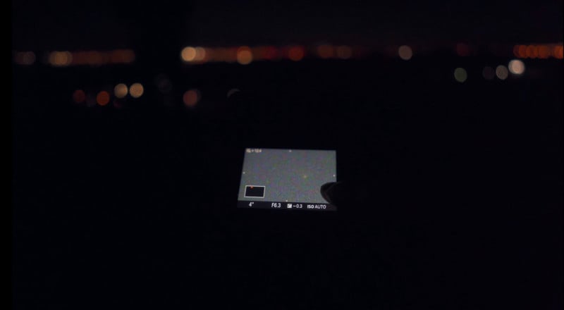 A camera pointed at the Madrid skyline at night