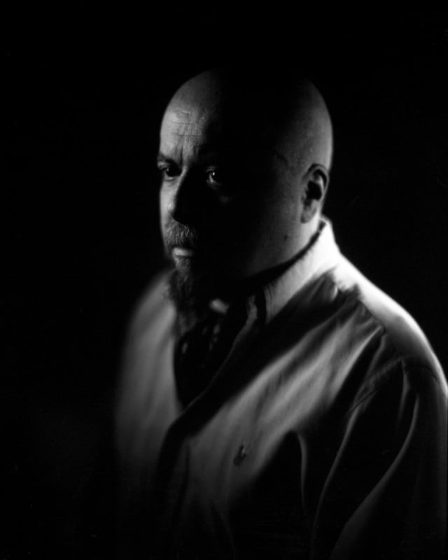 A black and white portrait of photographer Giovanni Savino