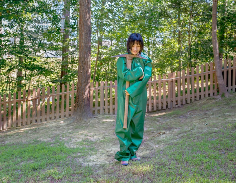 Girl in green outfit with mattock