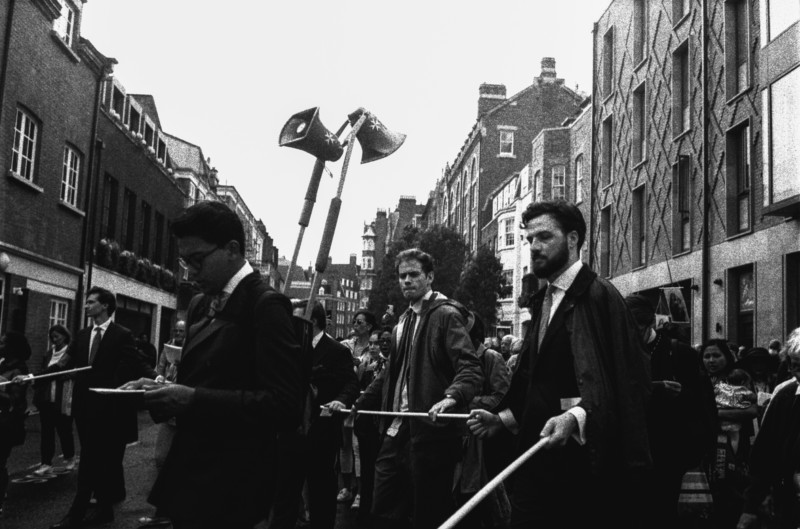 A group of protestors in a street holding sticks