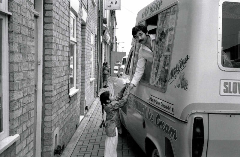 A girl getting ice cream from an ice cream truck