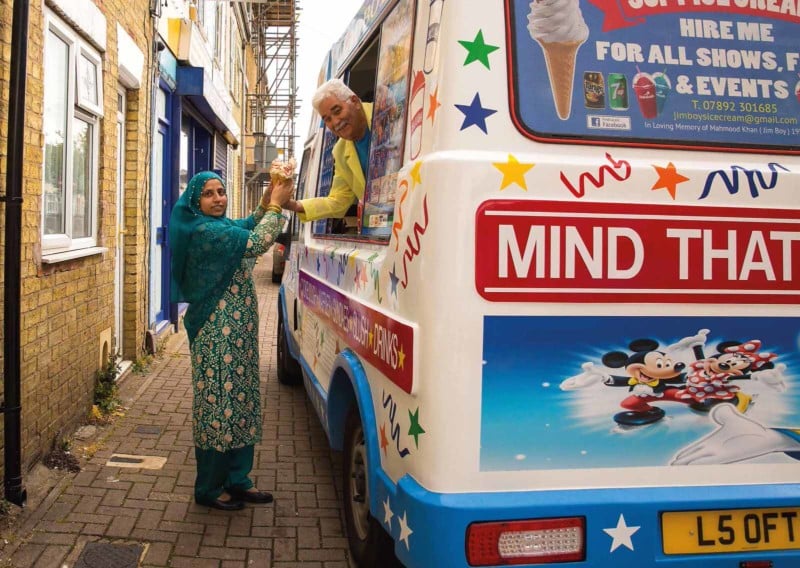 A woman getting ice cream from an ice cream truck