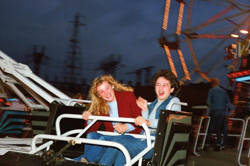 Two young women riding a ride at a fair