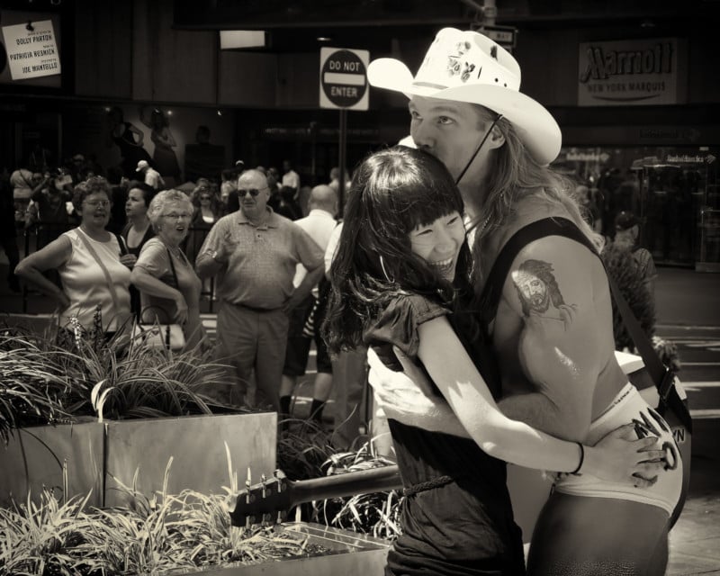 A cowboy kissing a woman