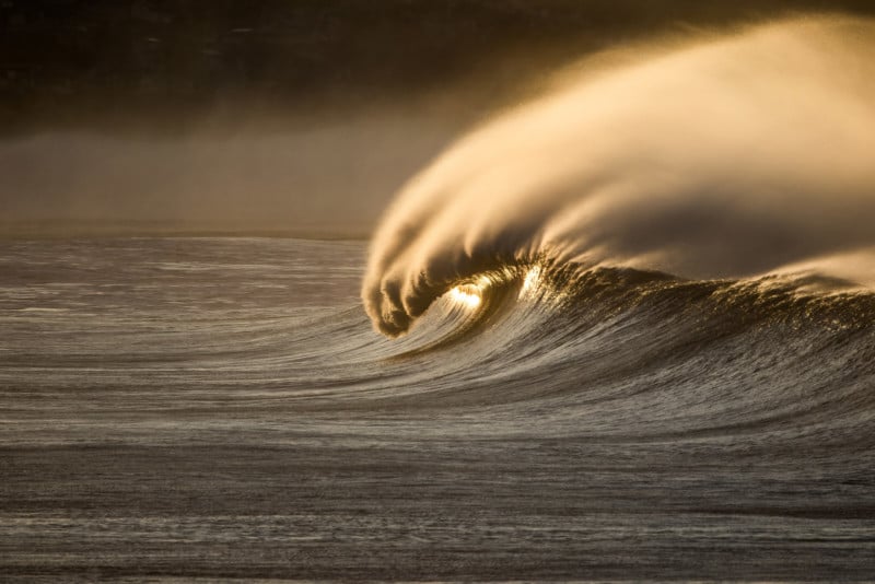 A photo of a golden wave crashing on the ocean