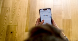 A woman holding a Google Pixel smartphone