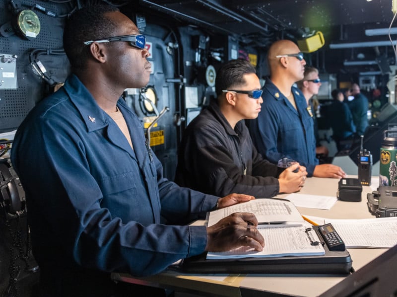 Observers watching a navy laser weapon test