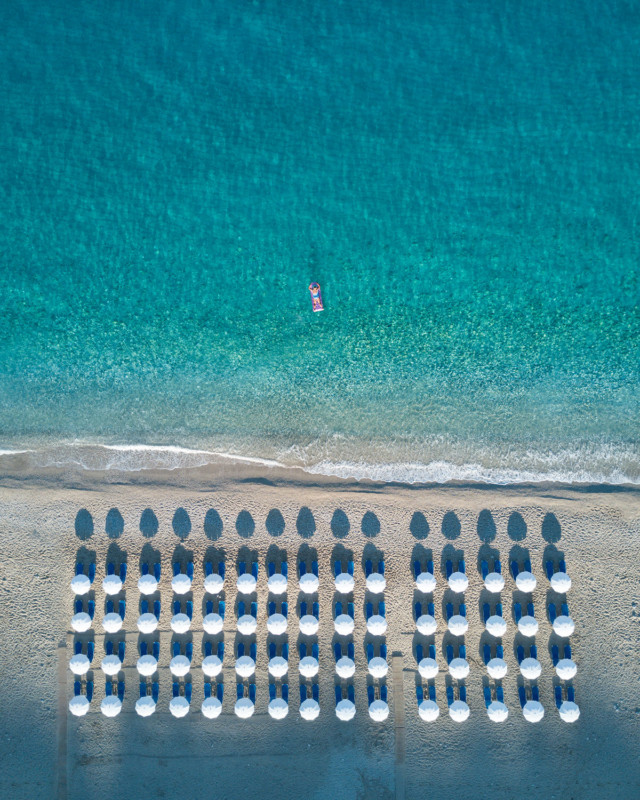 Aerial shot of sun loungers by the beach