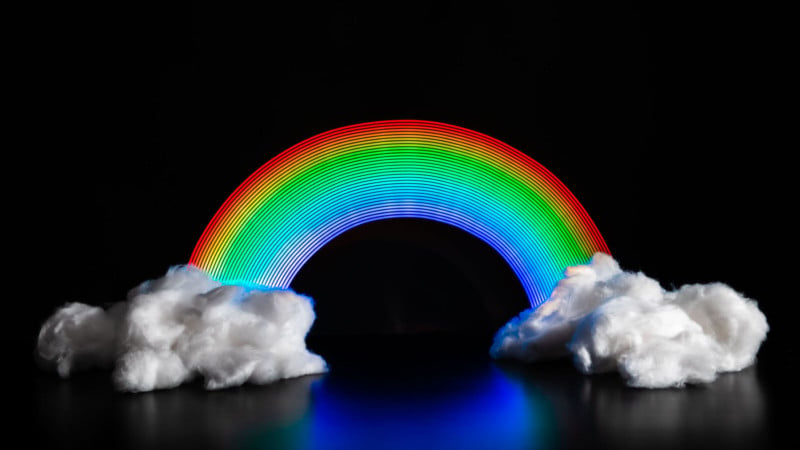 A rainbow painted with light on a black background