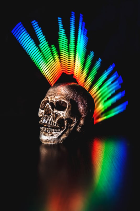A skull with colorful light painted effects around it