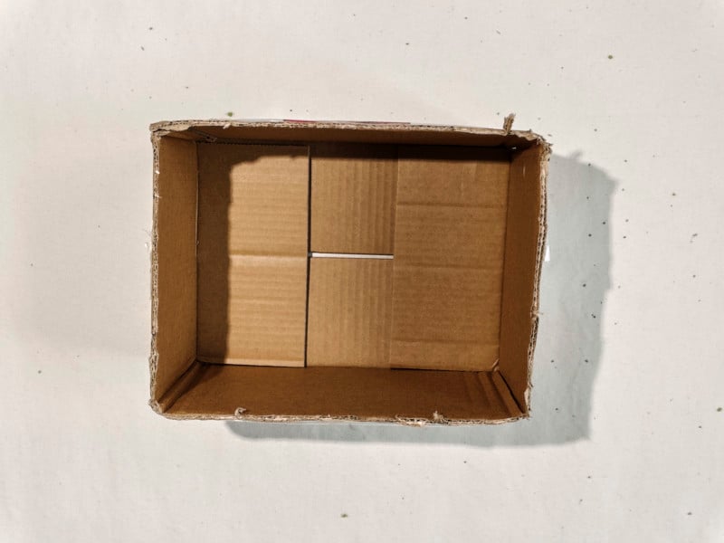 A cardboard box with its lid flaps cut off