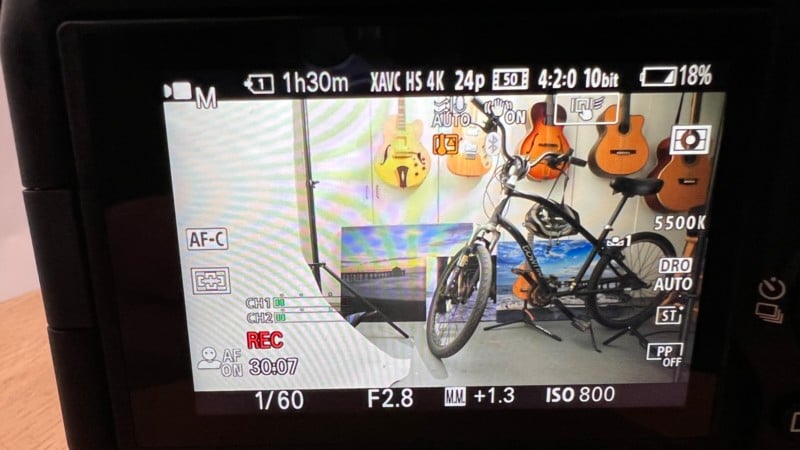 A Sony mirrorless camera live view with a bike in a garage