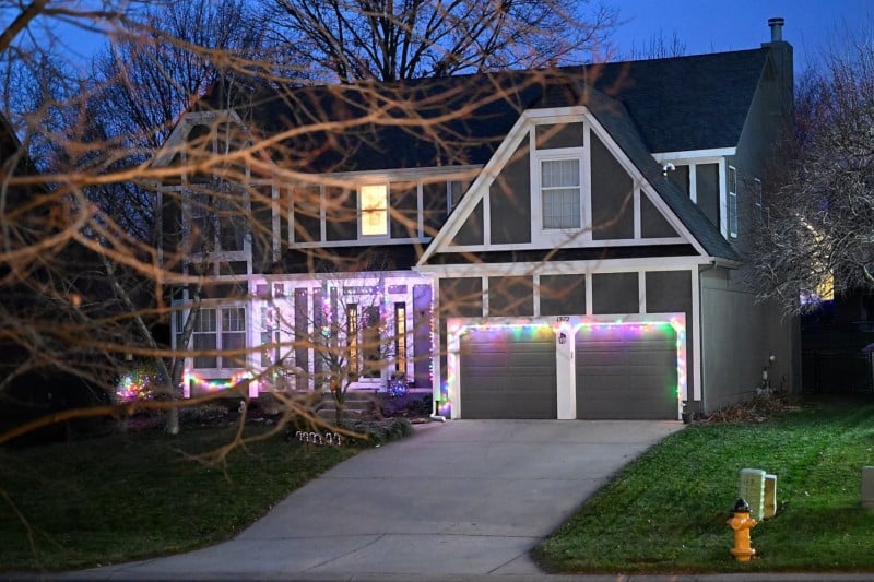 A photo of a house at night lit with Christmas lights