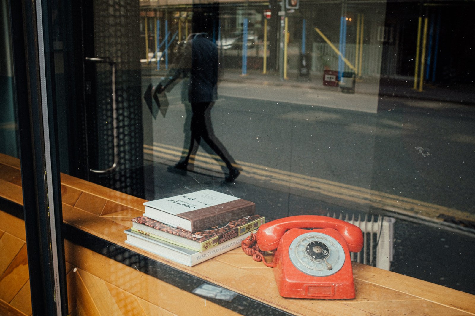 A reflection of a man in a shop window