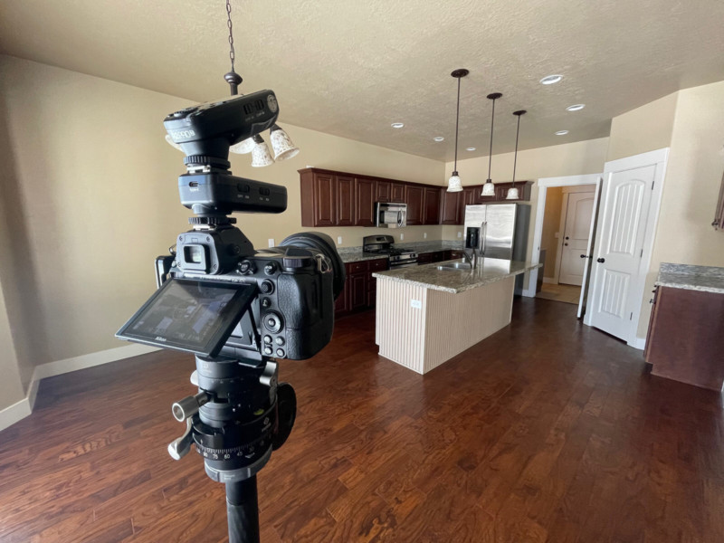 A camera and tripod set up for a kitchen real estate photo