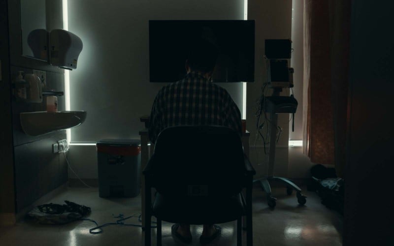 A patient sitting inside a room in Hong Kong's COVID hospital isolation