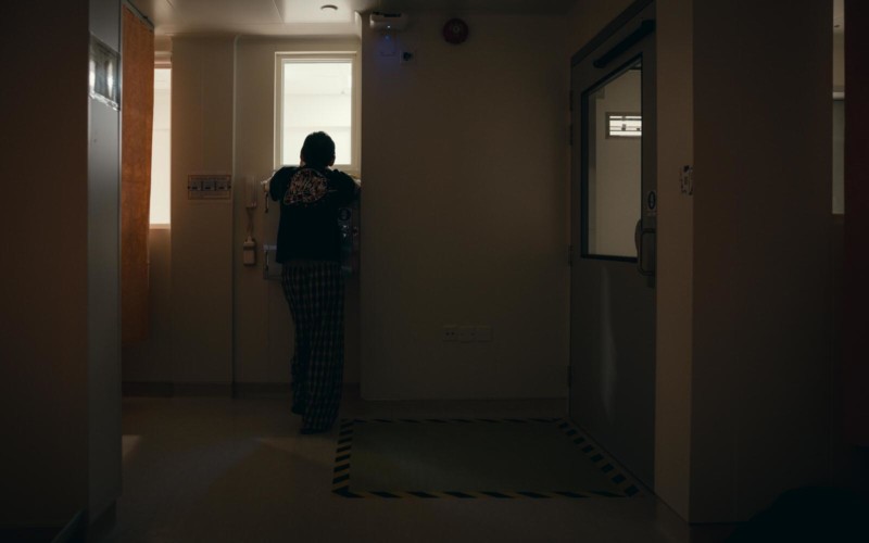 A patient looking out a window in Hong Kong's COVID hospital isolation