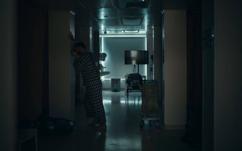 A patient standing in a hallway in Hong Kong's COVID hospital isolation