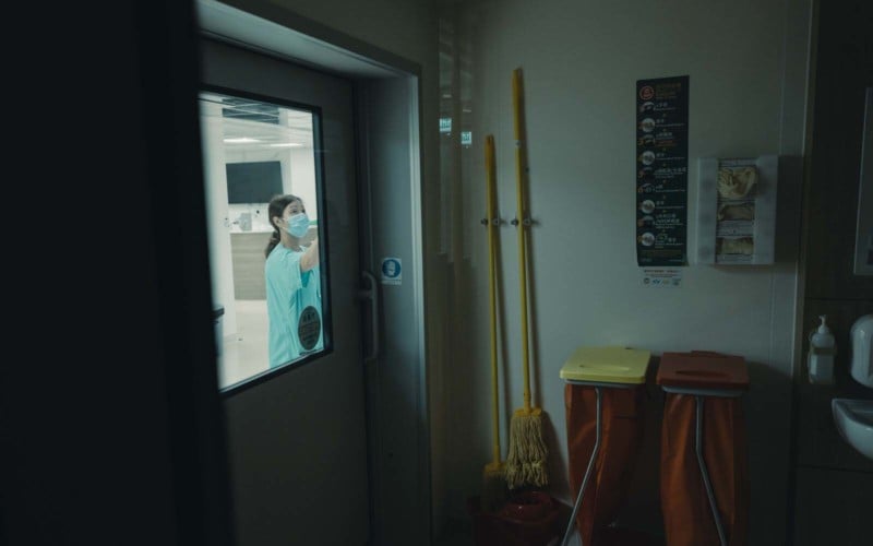 A nurse outside a door in Hong Kong's COVID hospital isolation