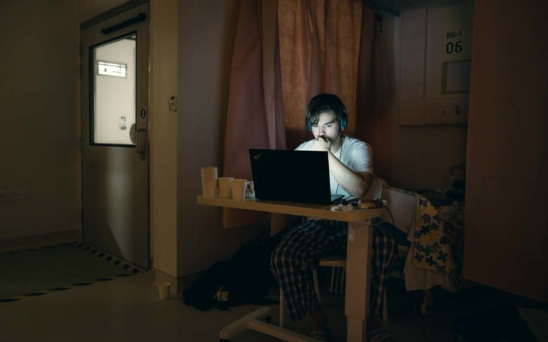 A man uses his laptop in Hong Kong's COVID hospital isolation