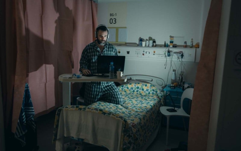 Photographer Matt Jacob uses his laptop in Hong Kong's COVID hospital isolation