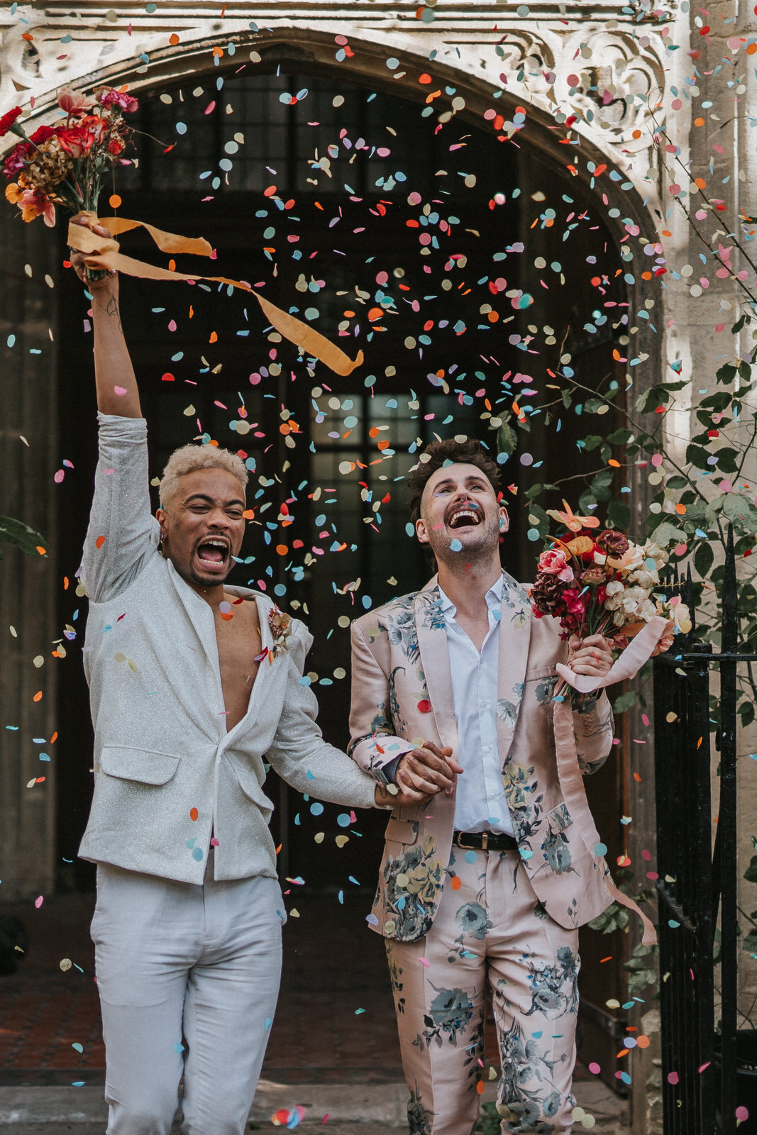 Two men getting married and walking through confetti