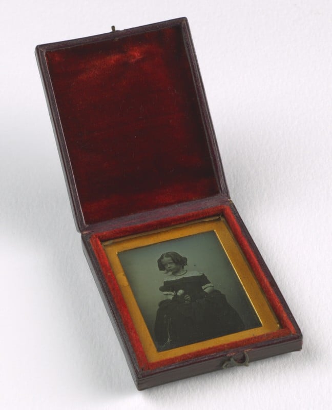 A black and white photograph in a velvet lined box