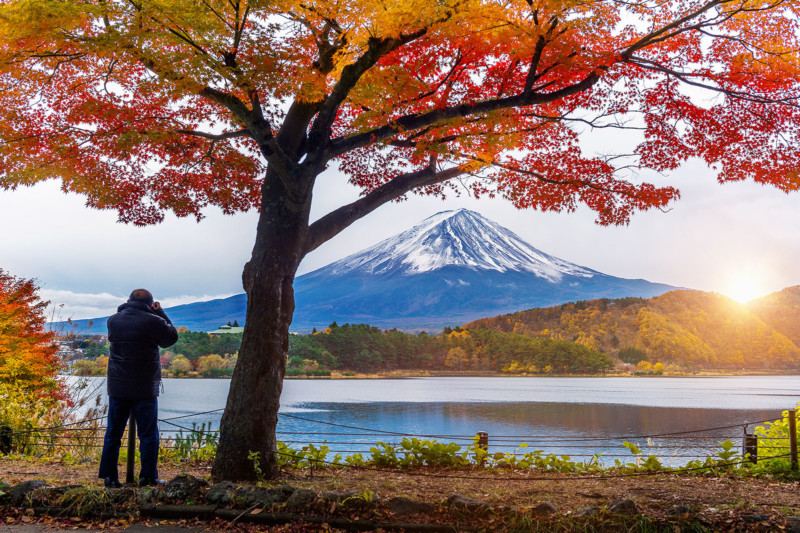 A photographer with a tripod photographing Mount Fuji in Japan