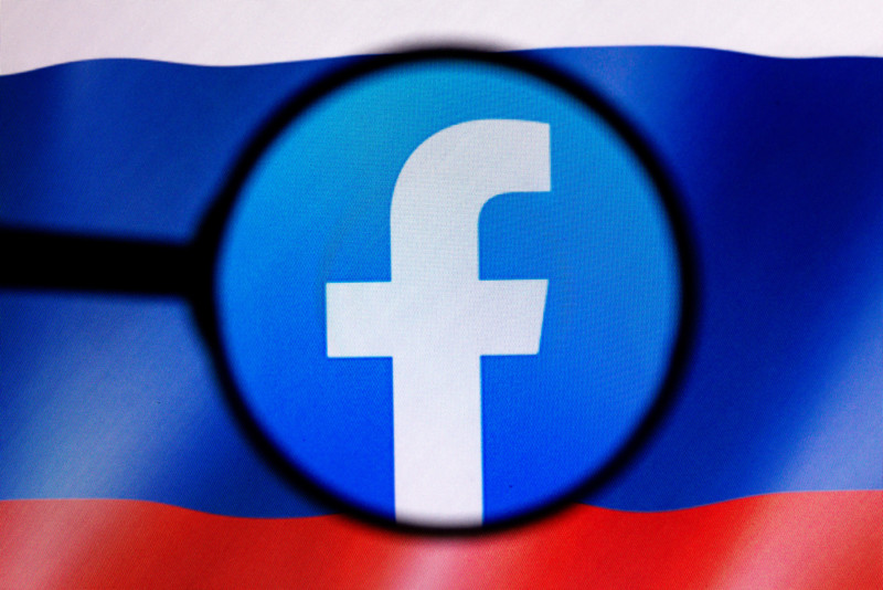 facebook logo over russian flag