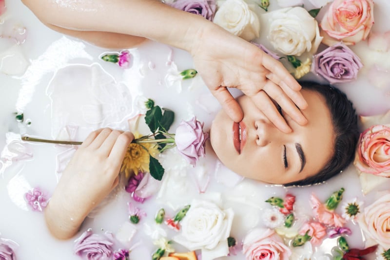 A woman takes a milk bath