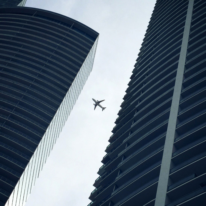 airplane framed by buildings