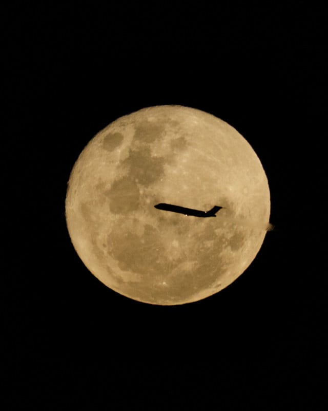buck moon with plane silhouette