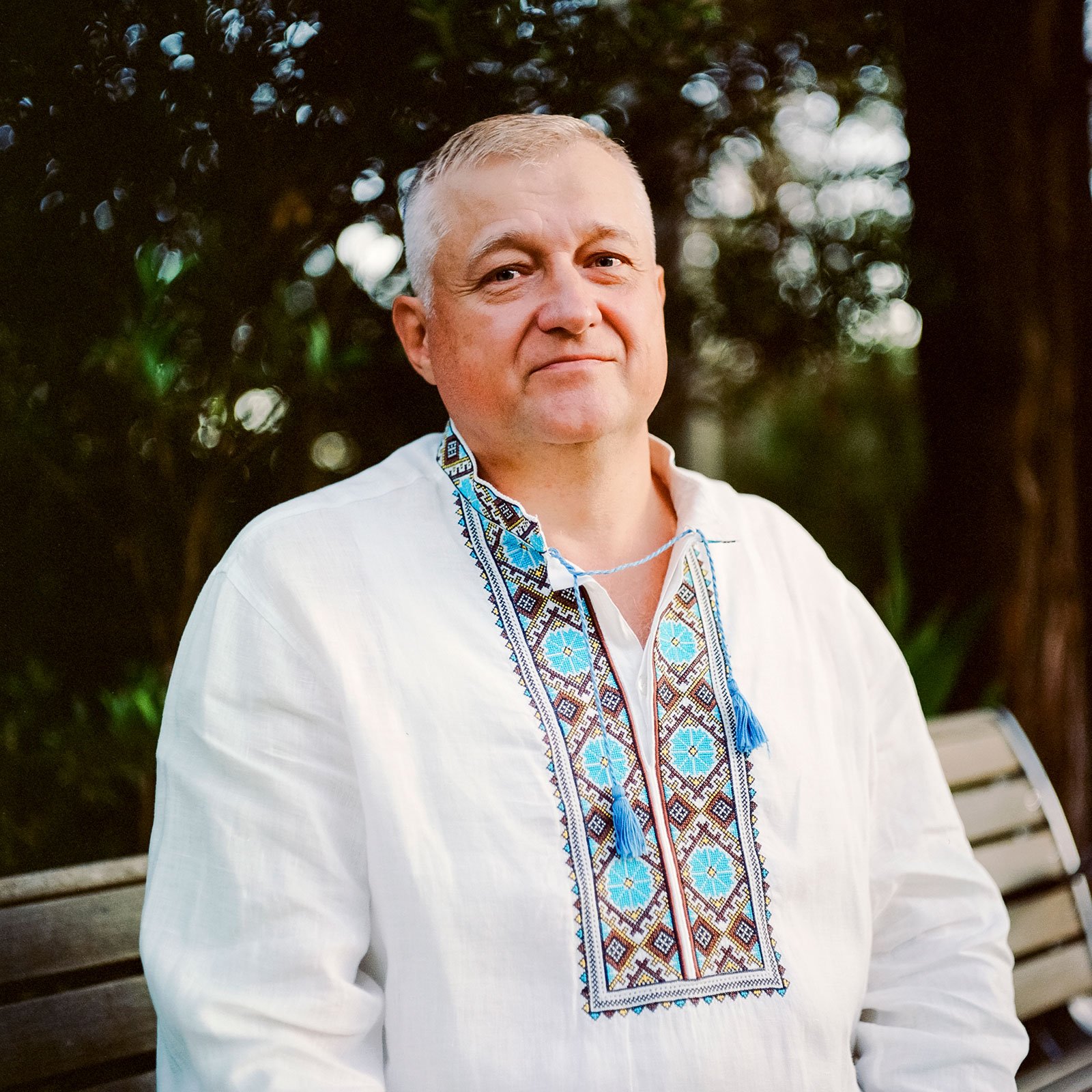 Older Ukrainian in traditional white and blue outfit