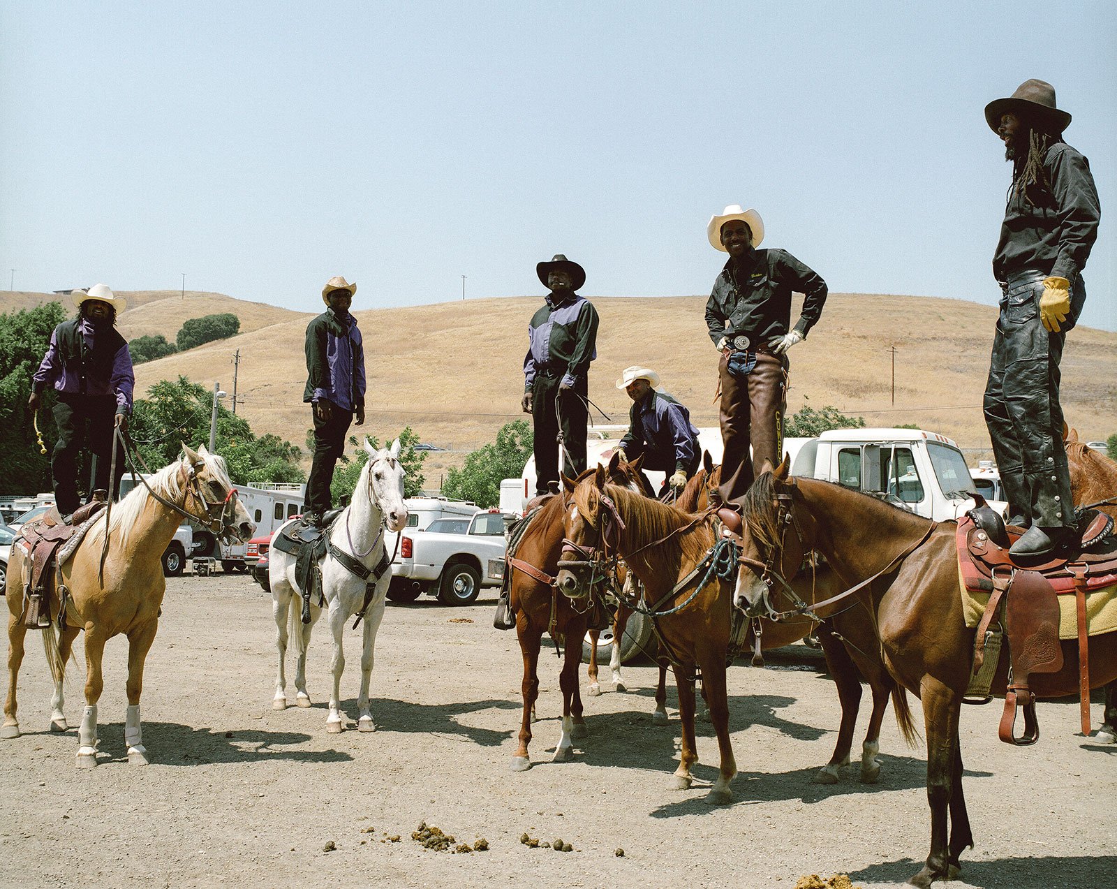 men standing on horseback