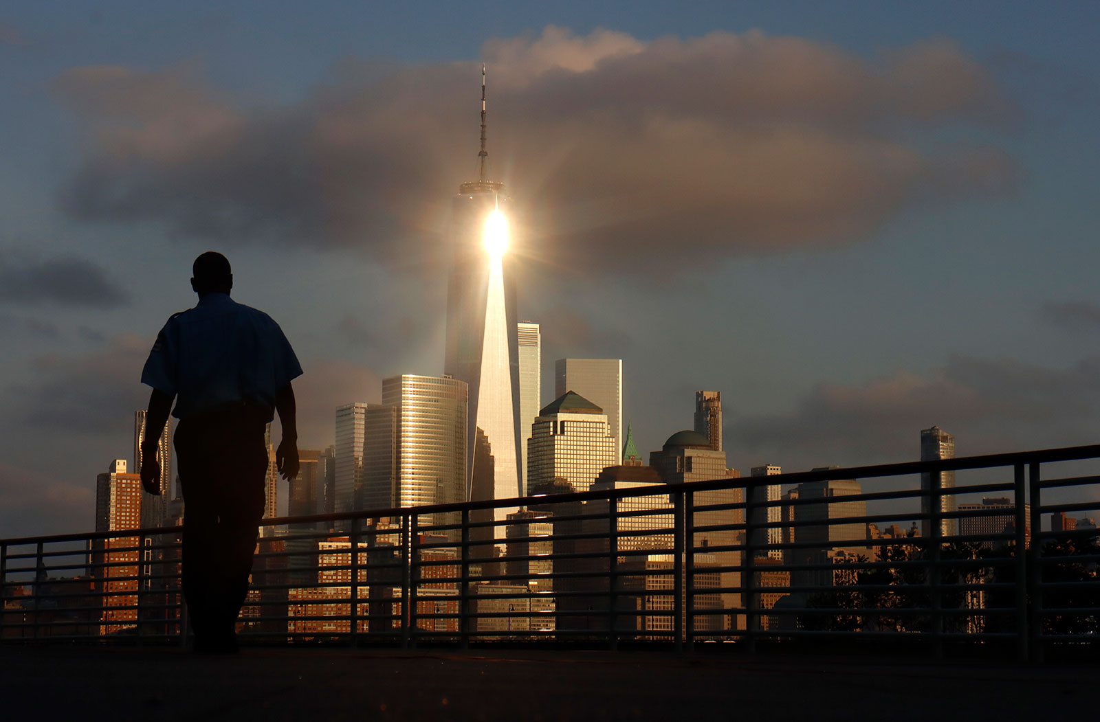 NYC skyline with bright building glisten and silhouette of man