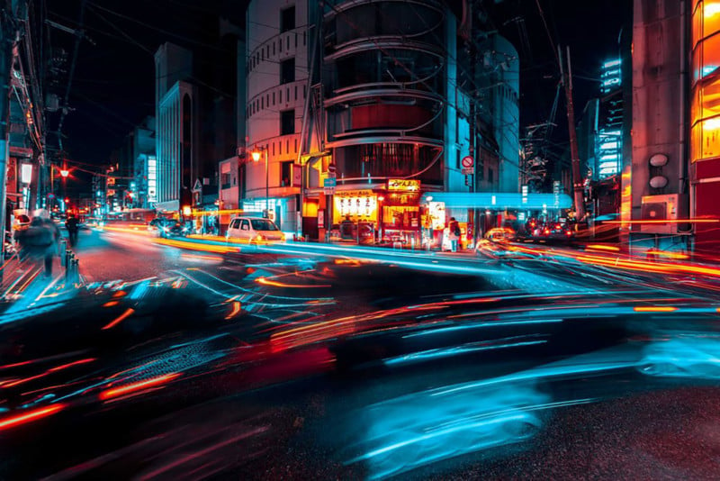 Street shot of Kyoto at night long exposure teal and red light crossing each other on a large roadway