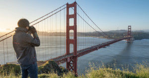 Photographer looking over the Golden Gate Bridge
