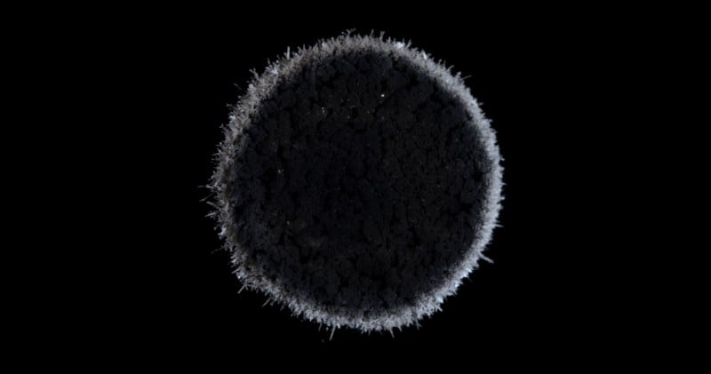 Scott Portingale: Chemical Somnia, silver chemical reaction with a spiked circle shaped orb and solid black background