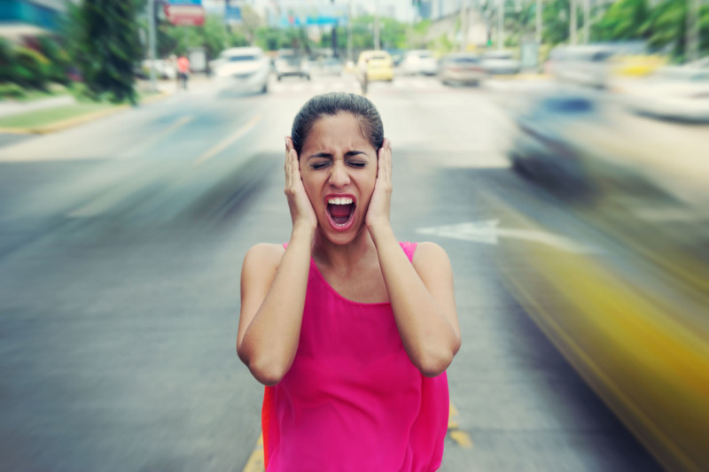 woman annoyed with city noise