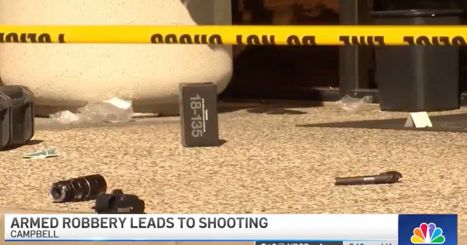 Guns and Lenses Scattered on the Sidewalk After Camera Store Robbery
