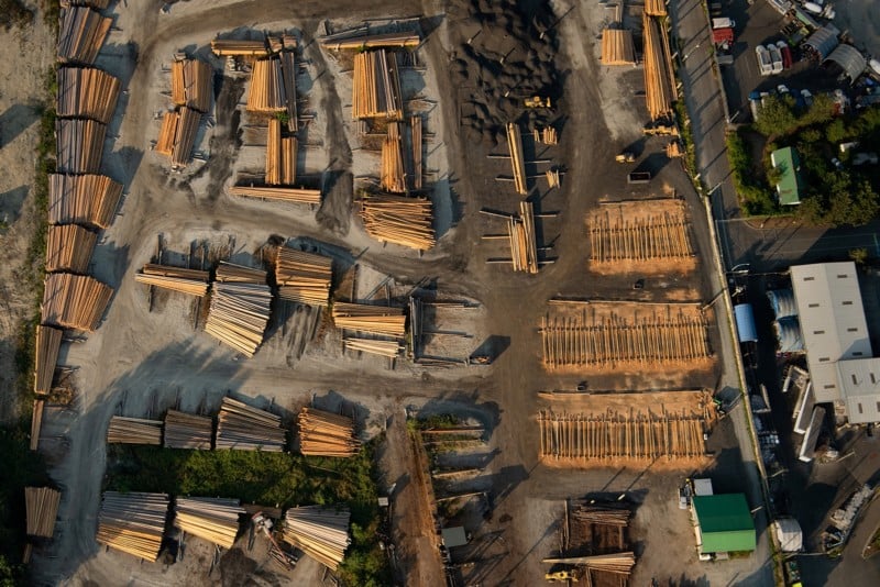 aerial view of a lumber yard and numerous bundles of timber and cleared forestry